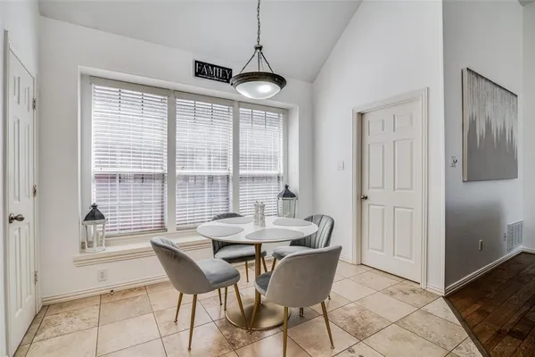 a dining room with furniture and window