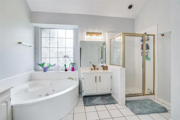 a bathroom with a bathtub and a shower