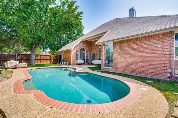 a view of a house with swimming pool and sitting area