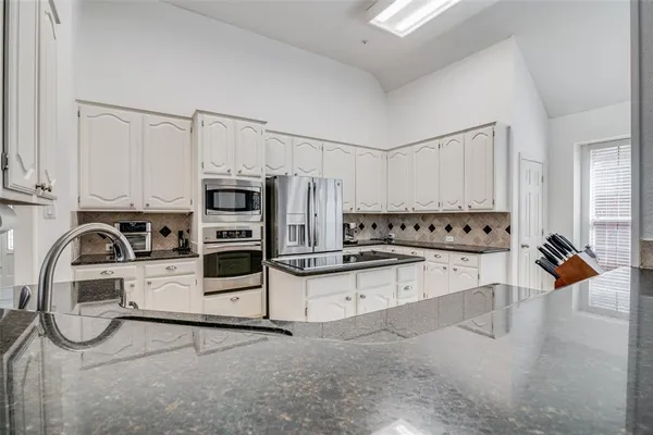 a view of a kitchen with electric appliances