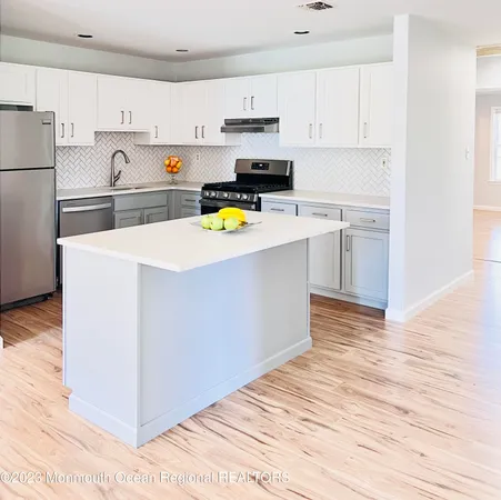 a view of kitchen with wooden floor