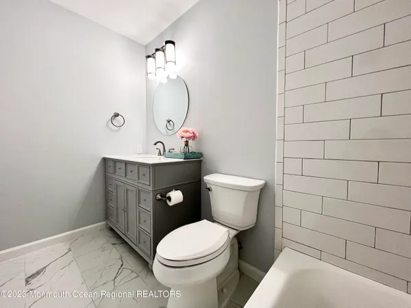 a white toilet sitting next to a bathroom sink