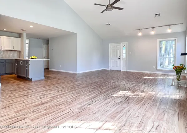 a view of a kitchen with wooden floor and a sink