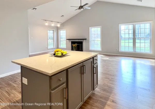 a kitchen with a sink a microwave and wooden floor