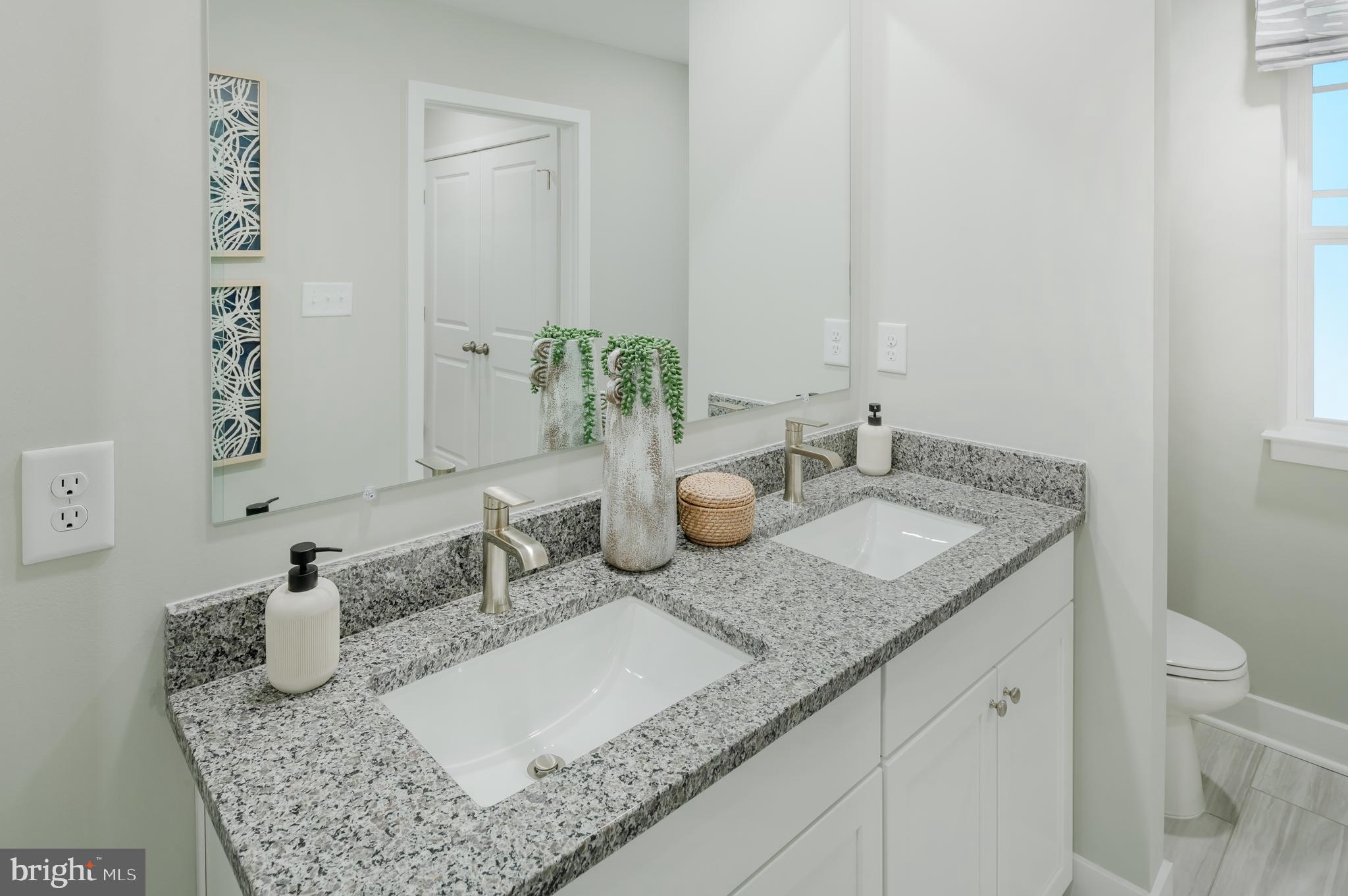 19017 Meadow Sun Way Boyds, MD 20841 - Photo 25 of 34 a bathroom with a granite countertop sink and a mirror