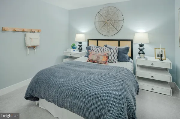 a bedroom with a bed and a painting on the wall
