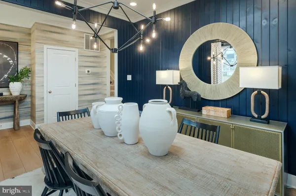 a dining room with furniture and wooden floor