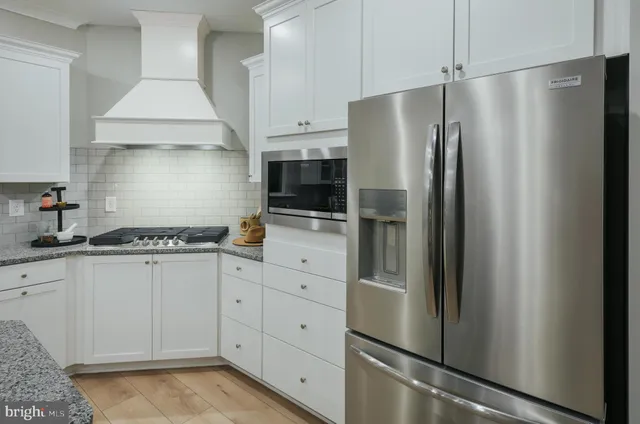 a kitchen with stainless steel appliances a refrigerator sink and cabinets