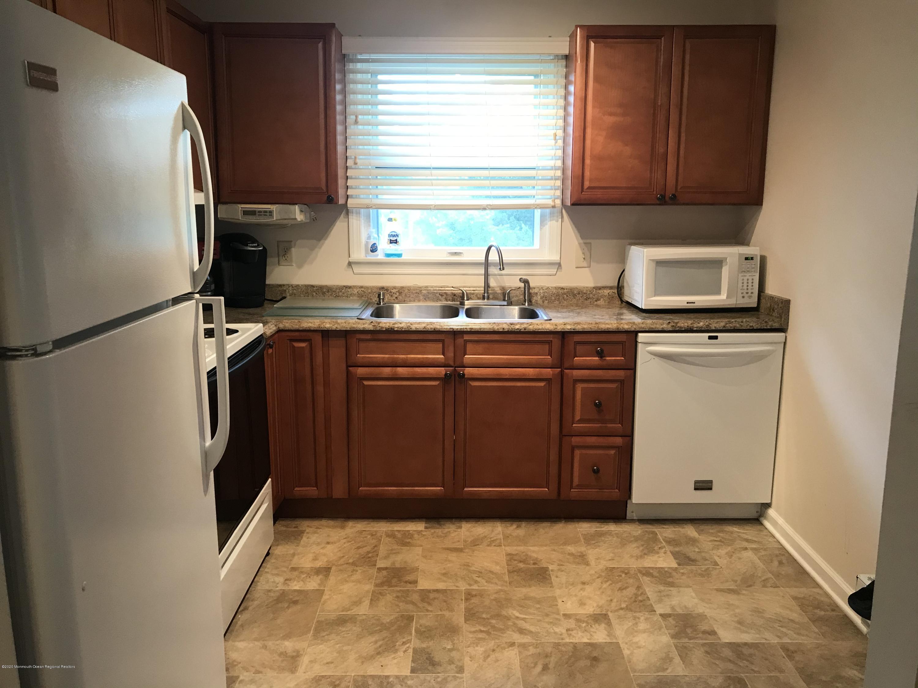 2 Cranberry Road, Unit 10A Manahawkin, NJ 08050 - Photo 8 of 20 a kitchen with stainless steel appliances a stove sink and refrigerator