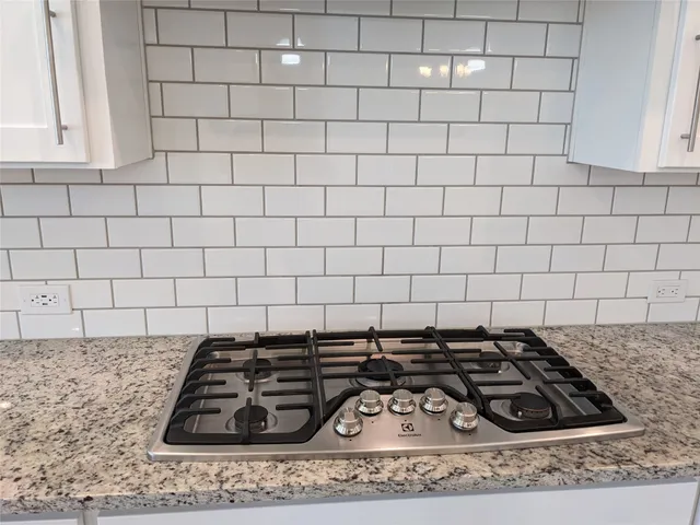 a kitchen with stainless steel appliances granite countertop a sink stove and microwave