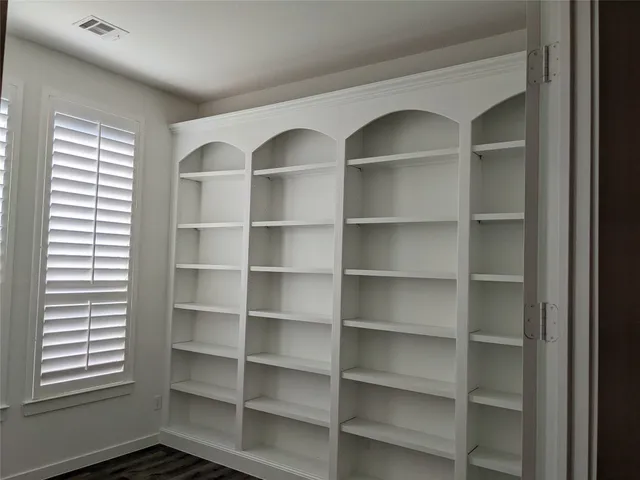a view of a room with shelves on the wall