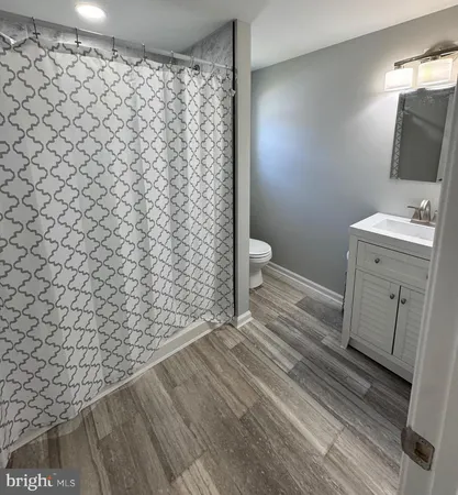 a bathroom with a toilet and a shower curtain