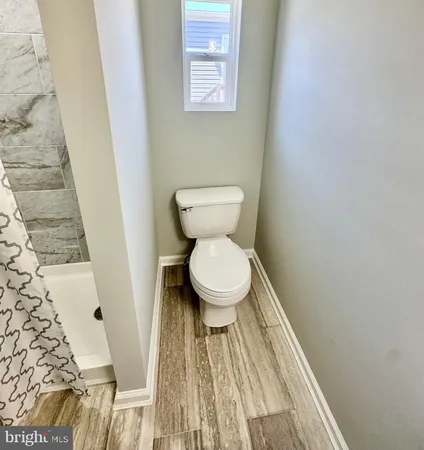 a bathroom with a toilet and a rug