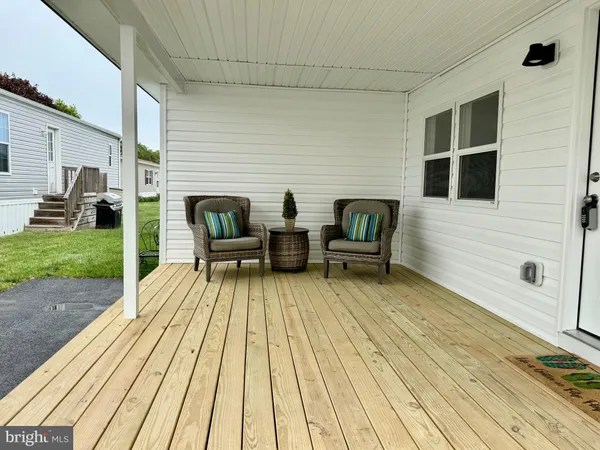 a view of deck with table and chairs with wooden floor and fence