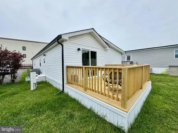 a view of backyard with deck and garden