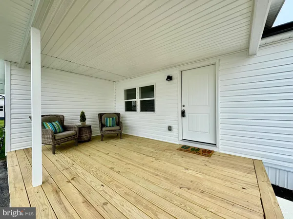 a view of a patio with table and chairs with wooden floor and fence