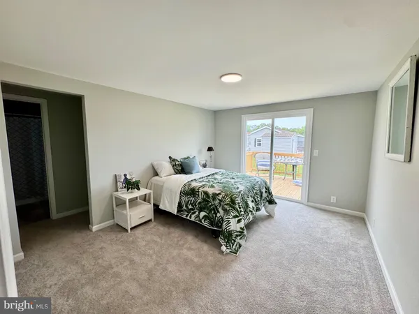 a spacious bedroom with a bed and a window