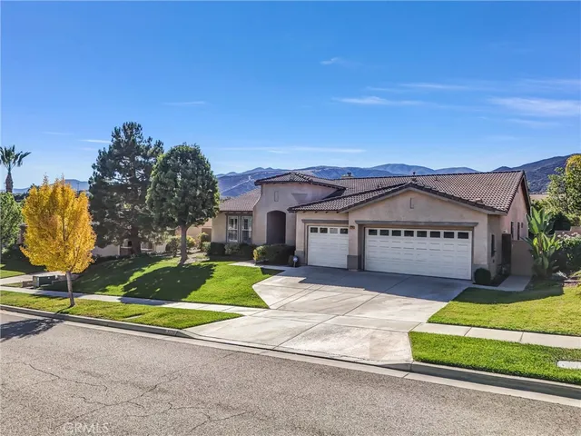 a house with green field in front of it