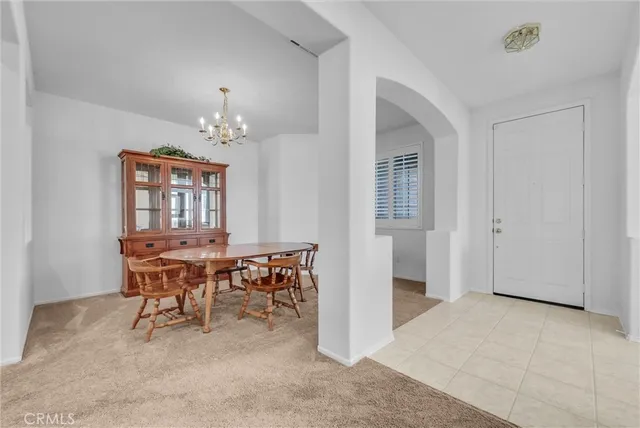 a view of a dining room with furniture and chandelier