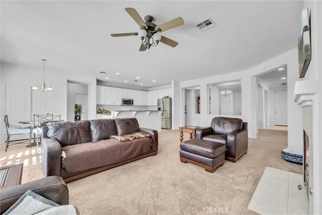 a living room with furniture and a ceiling fan