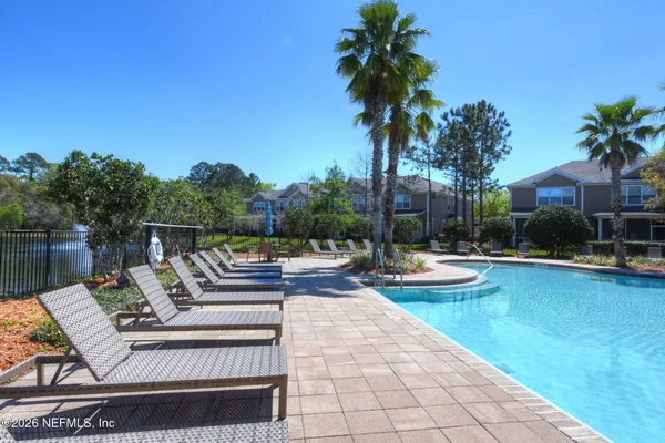 a view of a house with swimming pool and sitting area