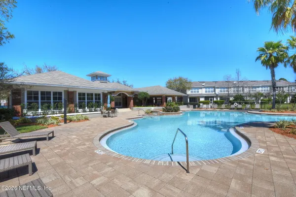 a swimming pool with outdoor seating and yard