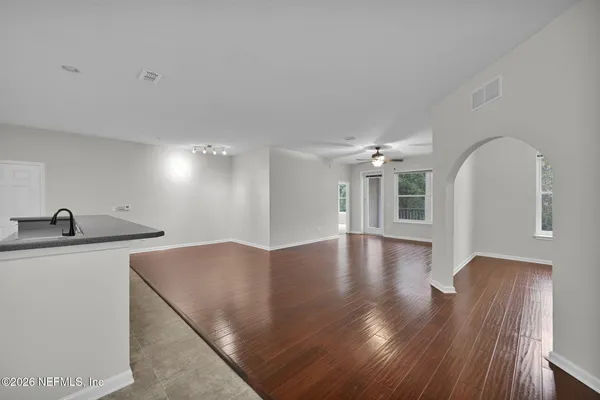 a view of a kitchen with wooden floor and a sink
