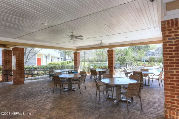 a dining room with furniture a chandelier and garden view