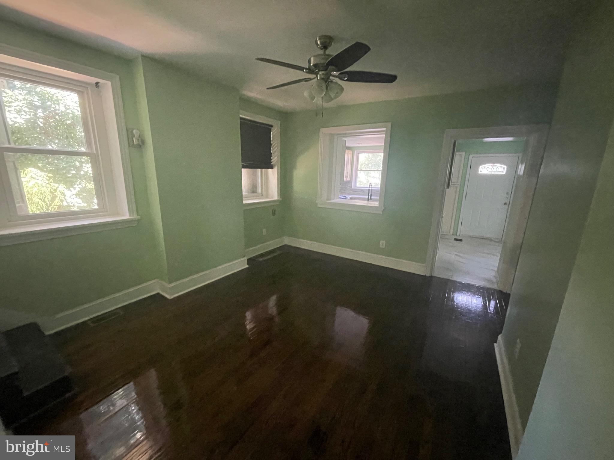 6416 Overbrook Avenue Philadelphia, PA 19151 - Photo 8 of 18 a view of an empty room with a window and wooden floor