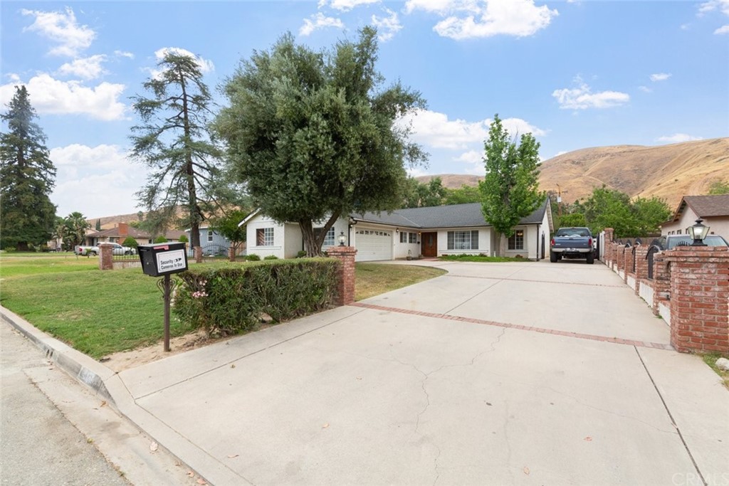 Welcome Home! Single Story home with long drive way and RV Access with Wrought Iron Gate.
