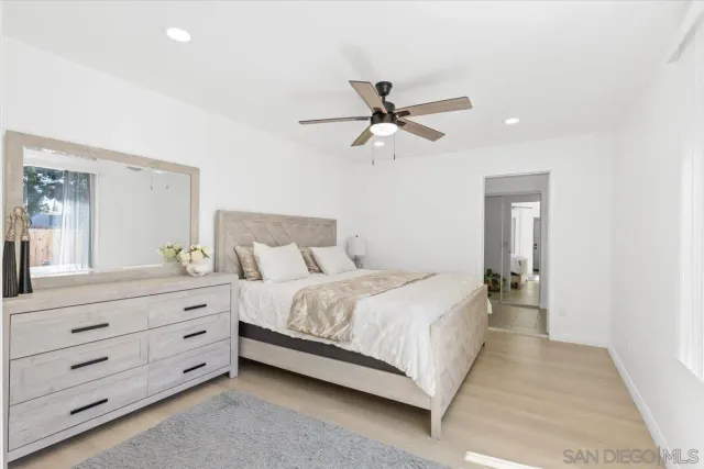 a bedroom with a large bed and a chandelier