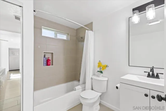 a bathroom with a sink mirror vanity and toilet