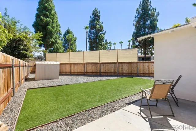 a view of a backyard with sitting area