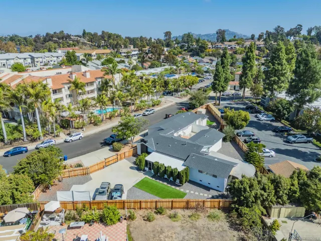 an aerial view of a house with a yard and sitting area