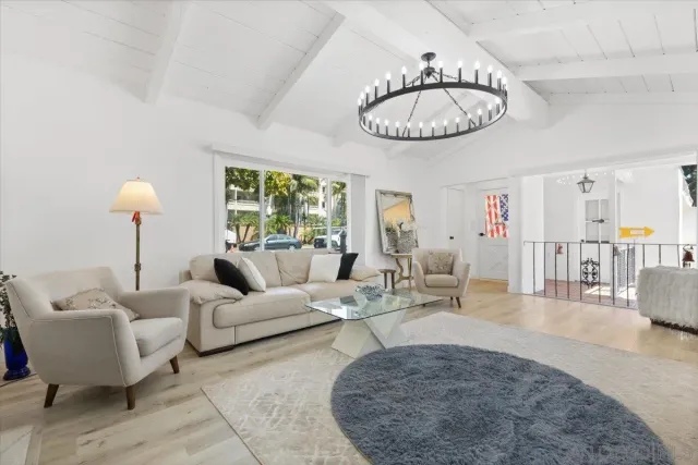 a living room with furniture a table and a large window
