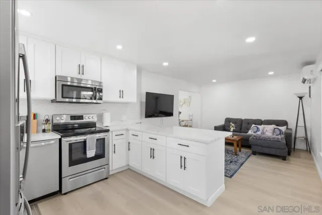 a kitchen with stainless steel appliances a stove a sink and a refrigerator