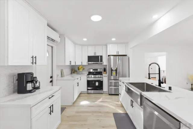 a kitchen with stainless steel appliances granite countertop a sink stove and refrigerator