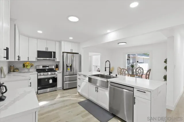 a kitchen with a sink stainless steel appliances and cabinets