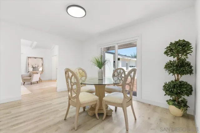a dining room with furniture and wooden floor