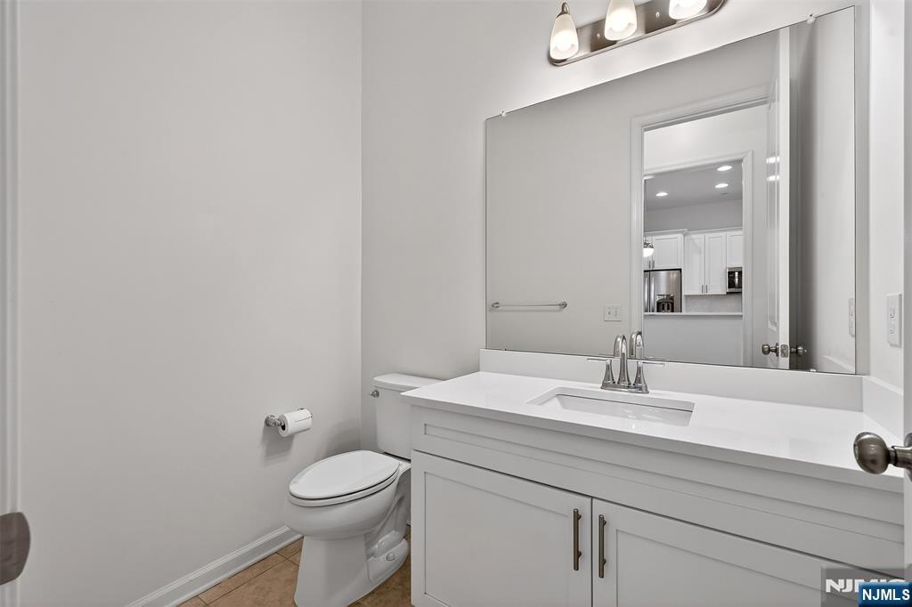 215 Roosevelt Drive Wood-Ridge, NJ 07075 - Photo 20 of 50 a bathroom with a sink a toilet and mirror