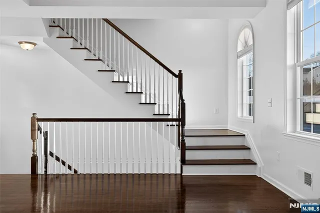 a view of a balcony with wooden floor and fence