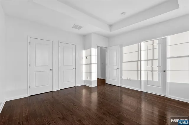 a front view of residential houses with yard and green space