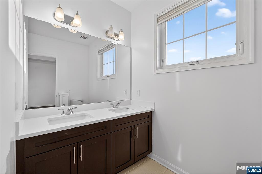 215 Roosevelt Drive Wood-Ridge, NJ 07075 - Photo 28 of 50 a bathroom with a sink vanity and a mirror