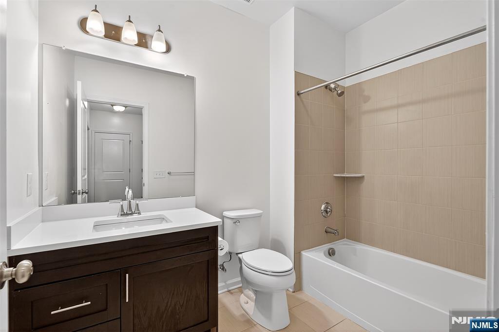 215 Roosevelt Drive Wood-Ridge, NJ 07075 - Photo 34 of 50 a bathroom with a sink a toilet and shower