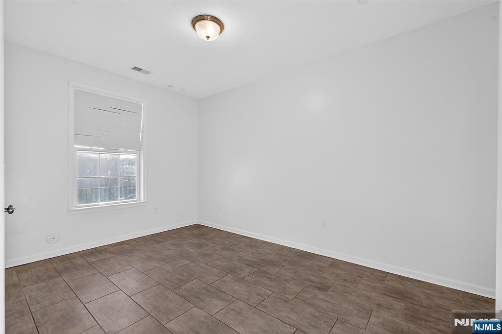 215 Roosevelt Drive Wood-Ridge, NJ 07075 - Photo 5 of 50 an empty room with windows