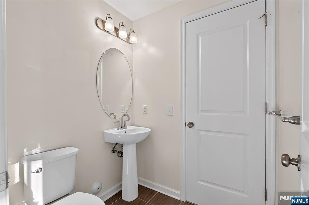 215 Roosevelt Drive Wood-Ridge, NJ 07075 - Photo 7 of 50 a bathroom with a sink toilet and a mirror