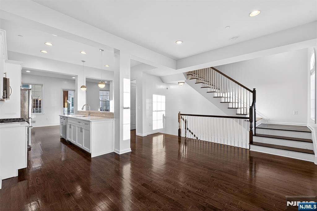 215 Roosevelt Drive Wood-Ridge, NJ 07075 - Photo 10 of 50 a view of entryway with kitchen and hall with wooden floor