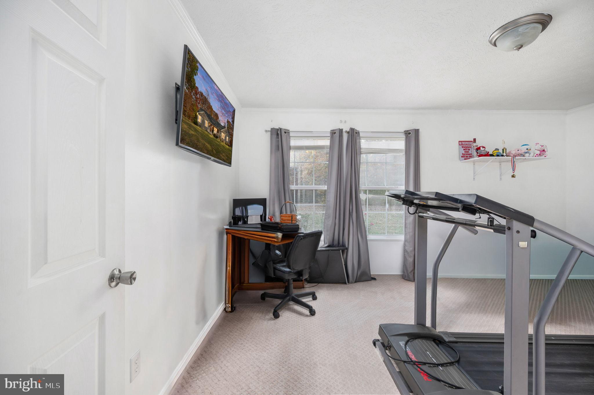 10325 Mill Pond Road Spotsylvania, VA 22551 - Photo 20 of 43 a view of a workspace with furniture and a window