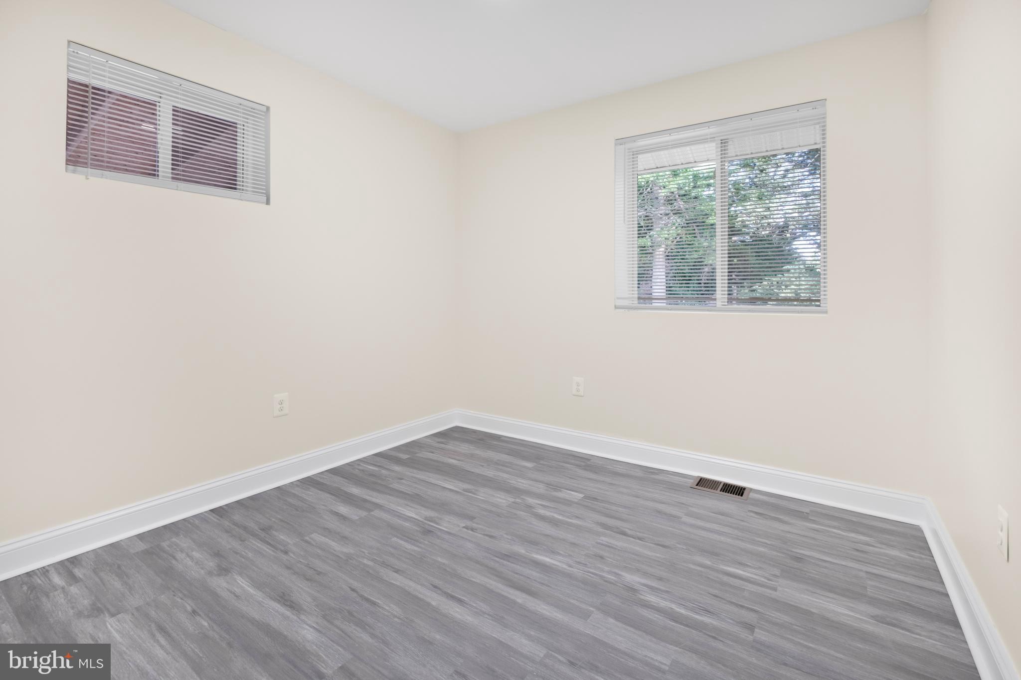 713 Marcy Avenue Oxon Hill, MD 20745 - Photo 11 of 24 an empty room with wooden floor and windows
