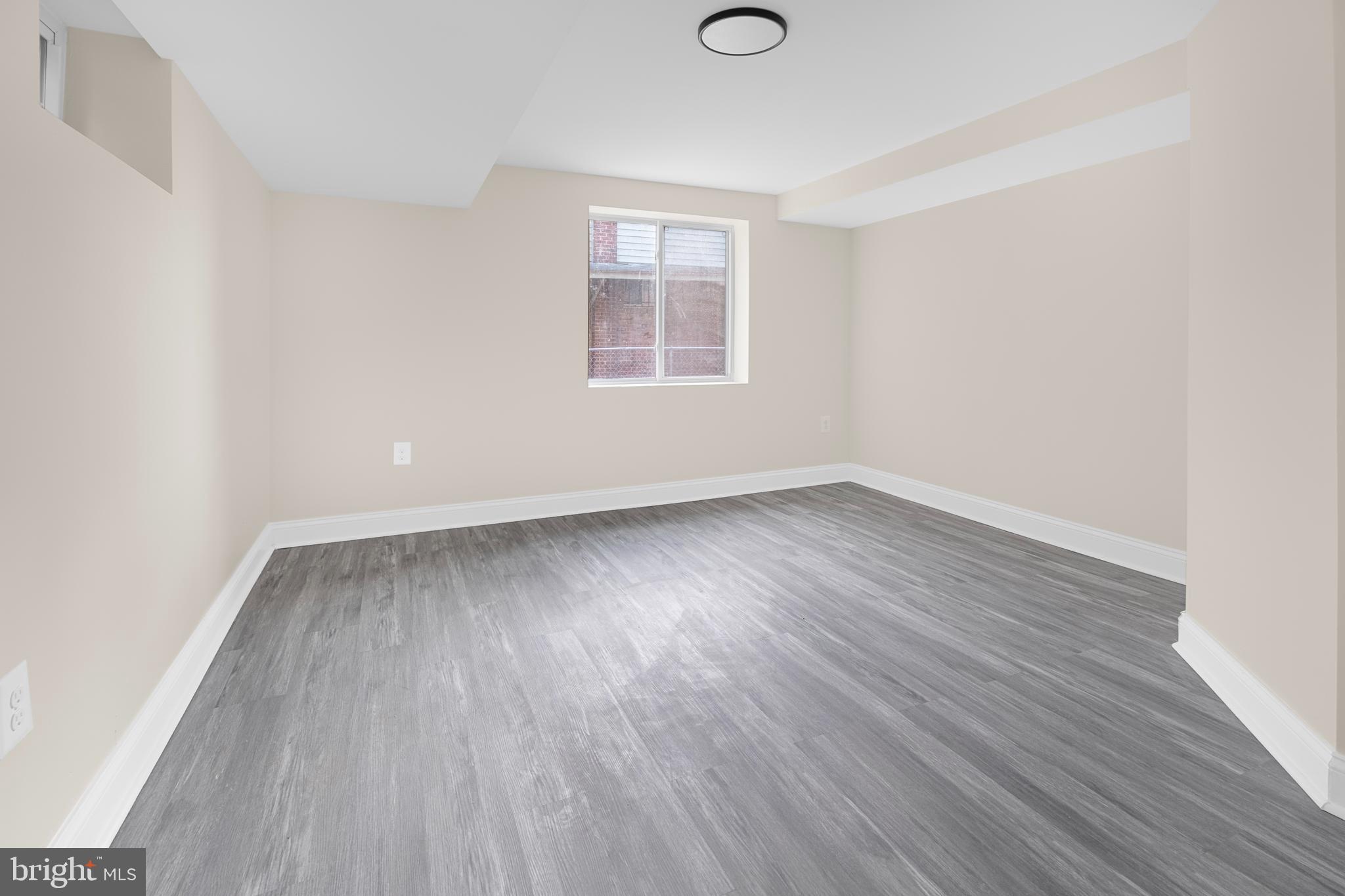 713 Marcy Avenue Oxon Hill, MD 20745 - Photo 12 of 24 an empty room with wooden floor and windows